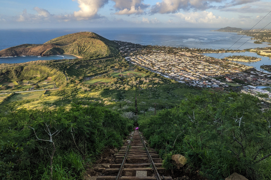 View of Oahu town while climbing down steep stairs of Koko Crater