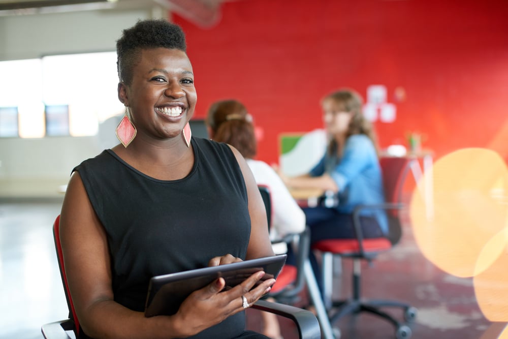 military spouse at an in-person networking event holding tablet