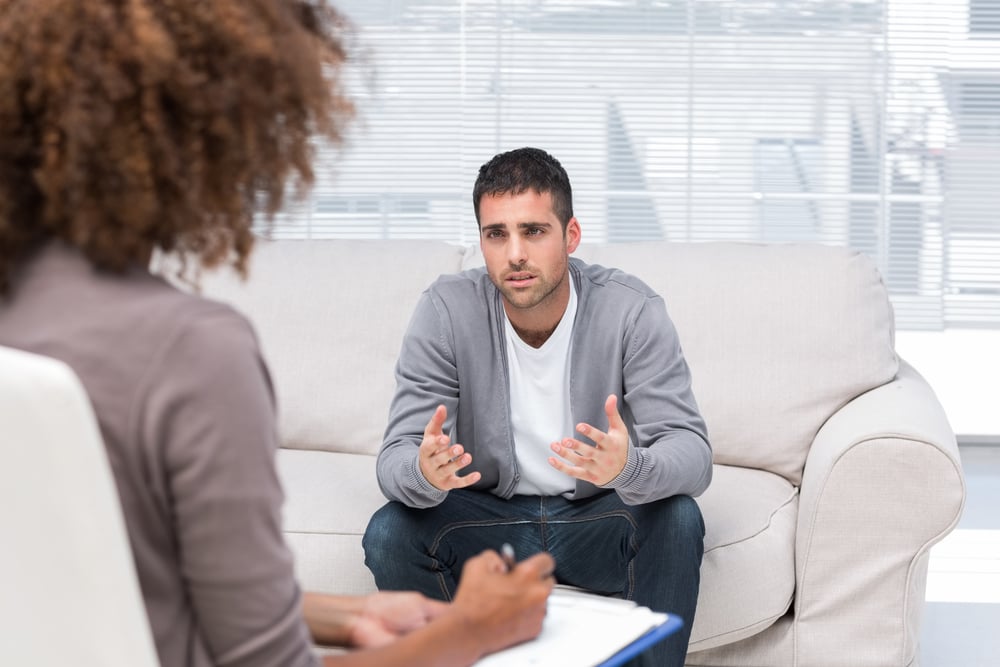 upset man talking to woman