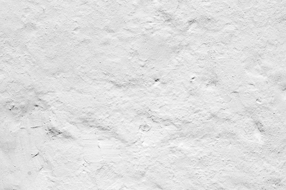 Detailed view of a white painted wall which has been weathered