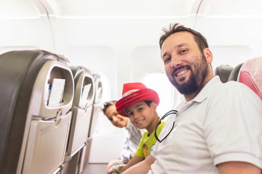 family traveling on airplane