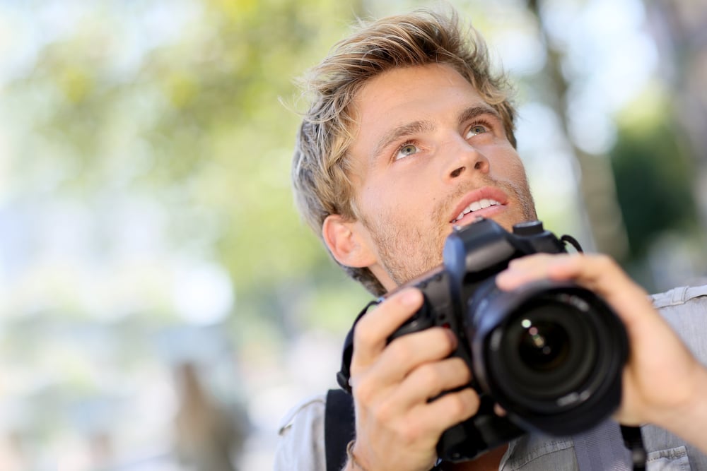 Photographer shooting outside with digital camera