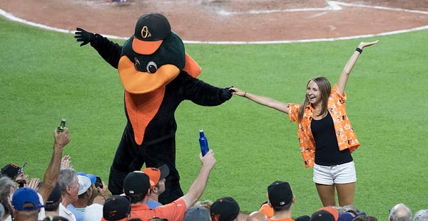 1024px-Baltimore_Orioles_Fan_and_the_Oriole_Bird_(35817598101)