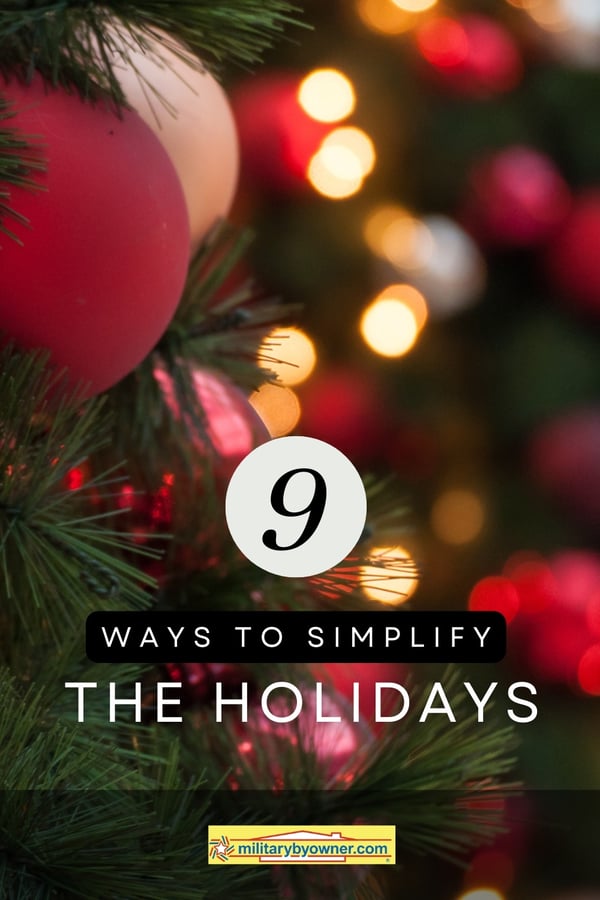 Christmas tree with bright red ornaments and white lights blurred in the background with text 9 ways to simplify the holidays-1