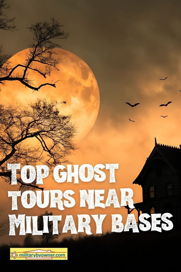 Spooky hillside with silhouette of haunted house, orange sky, bare trees, full moon, and birds with text, Top Ghost Tours Near Military Bases