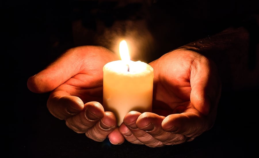 Hands holding candle 