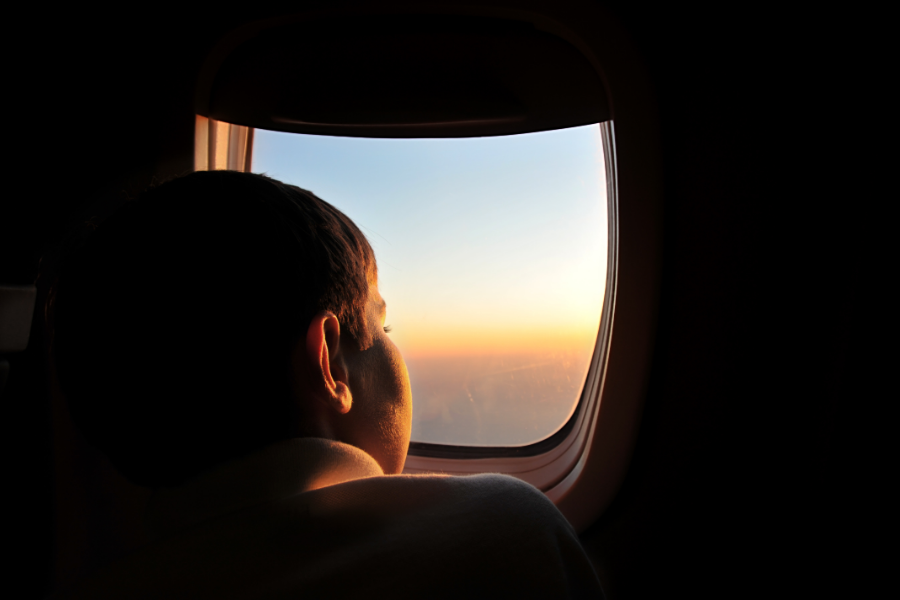 child looking out plane window