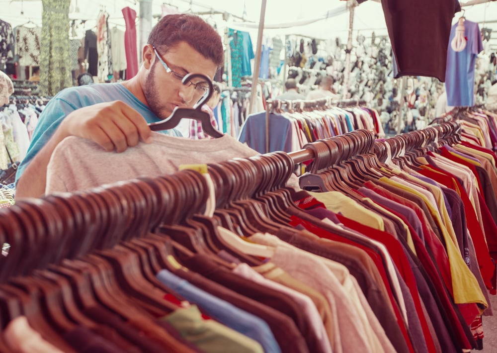 Young man buying in second hand store