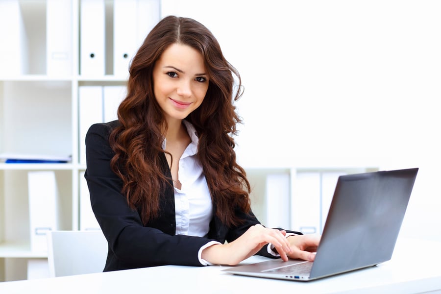 Young business woman with notebook in the office