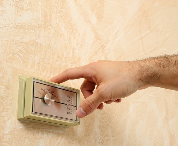 man checking HVAC system during home inspection