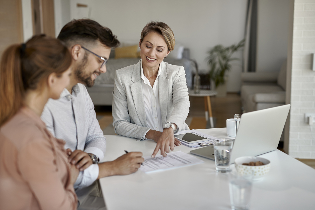 landlord looking at paperwork with tenants