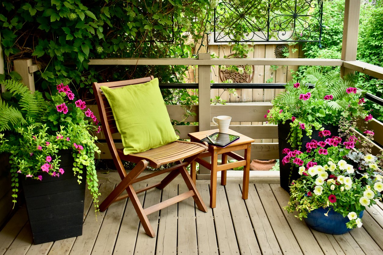 containers of flowers on back porch