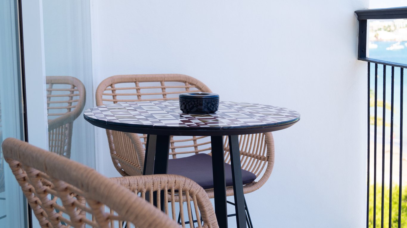 small bistro table and chairs on balcony