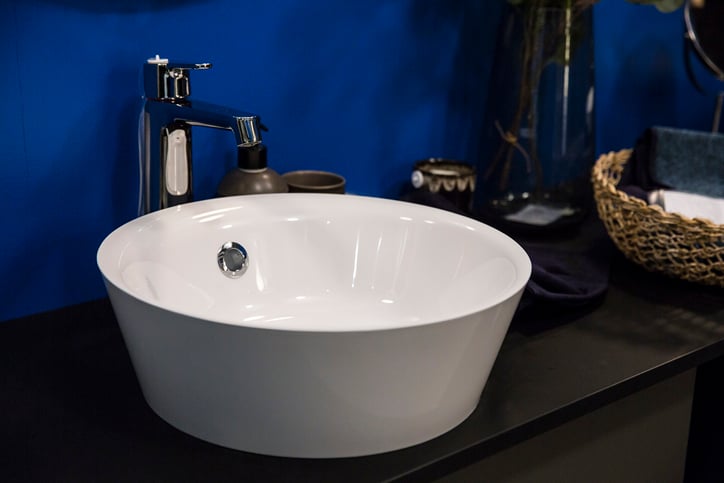 white bowl sink with blue painted wall