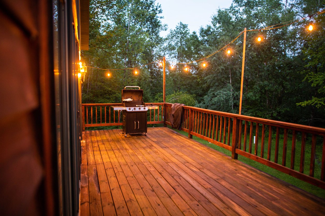 string lights on beautiful deck with grill