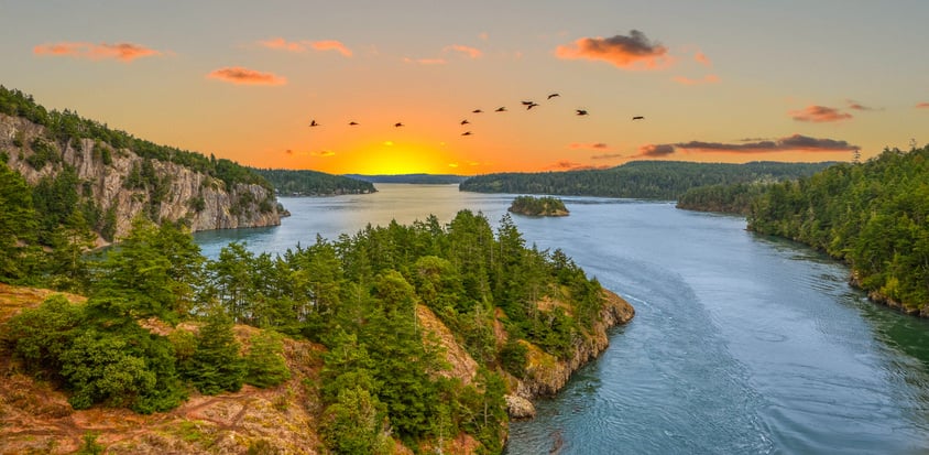 view of Deception Pass sunset, clouds, and trees,a waterway separating Whidbey Island from Fidalgo Island, in the U.S. state of Washington.