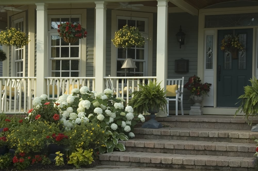 beautiful home with covered front porch and flowers