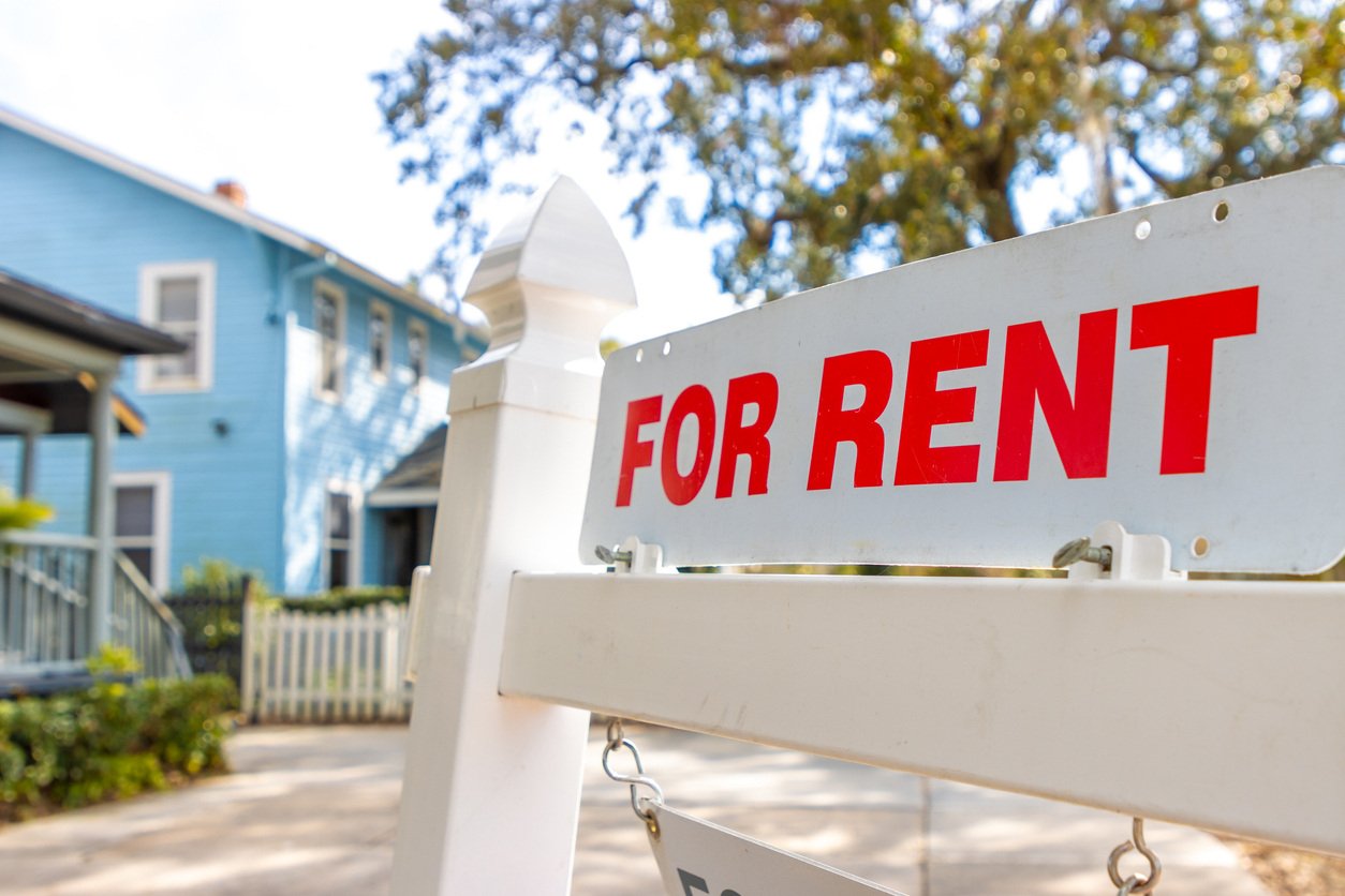 rental home with for rent sign in yard